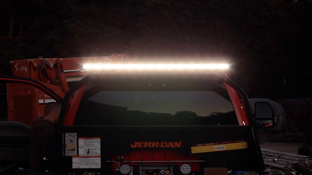 Tow truck light bar lit up at night